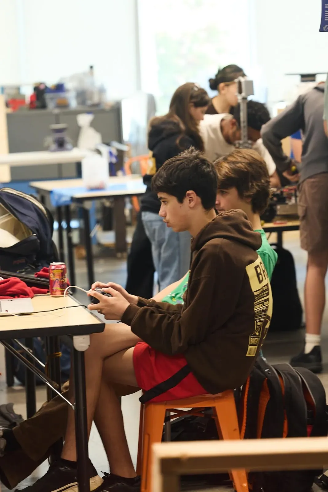 A student working with materials at a maker workbench