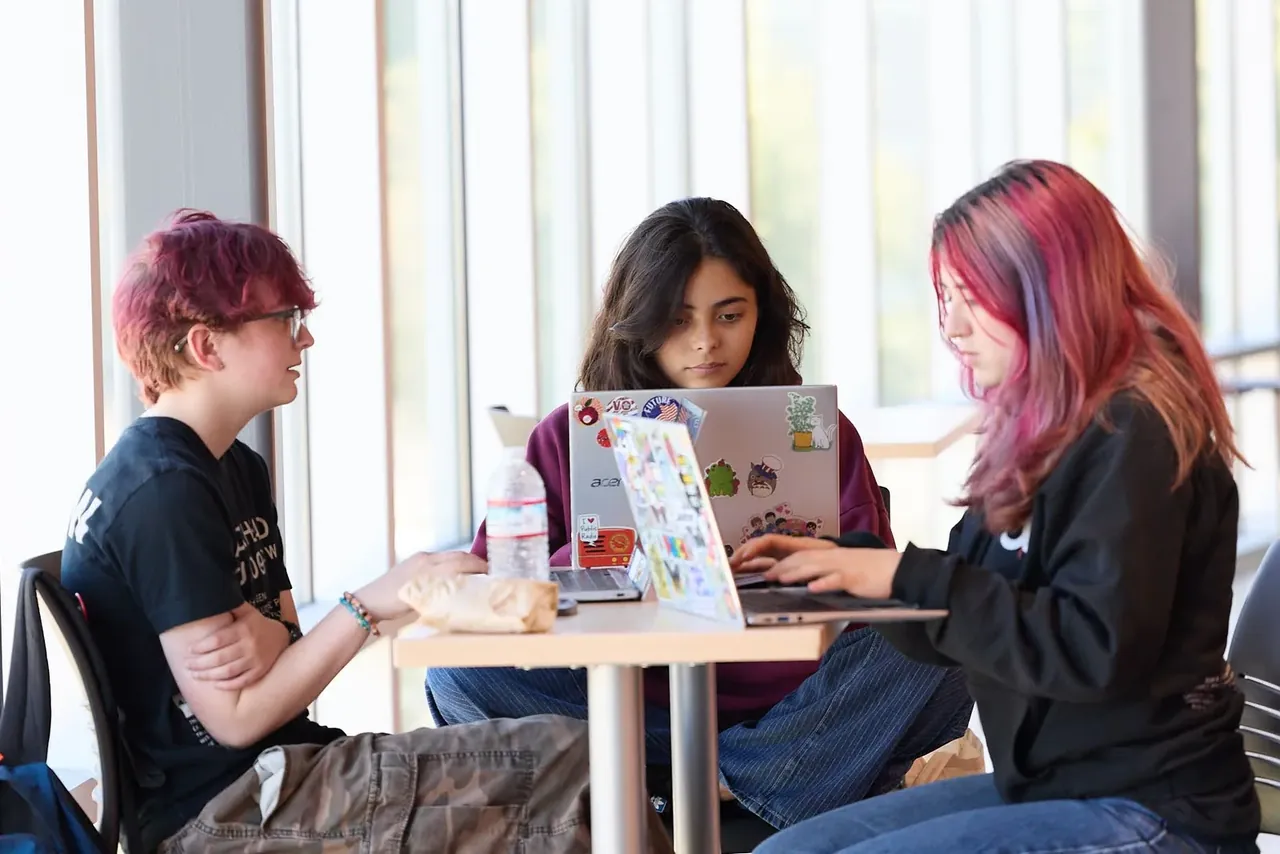 Students working together around a table on a design project