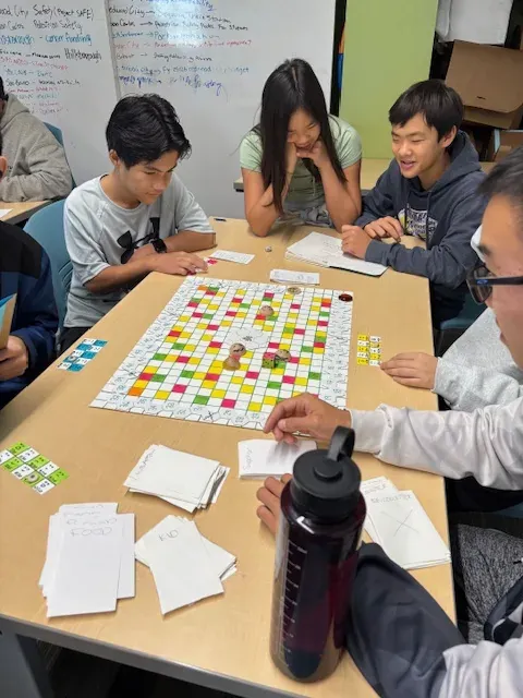 Students testing a hands-on project together at a table